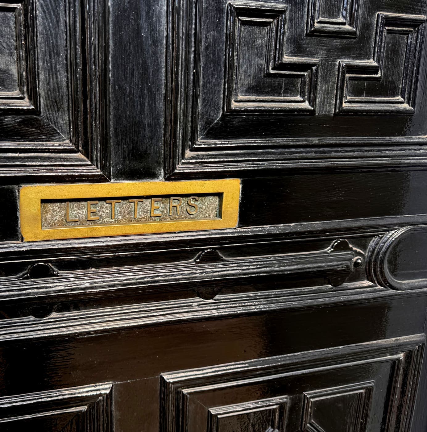 Detail of the front door's brass letterbox, engraved Letters